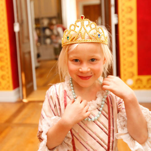 Als Prinzessin verkleidetes Mädchen spielt im Residenzschloss.
